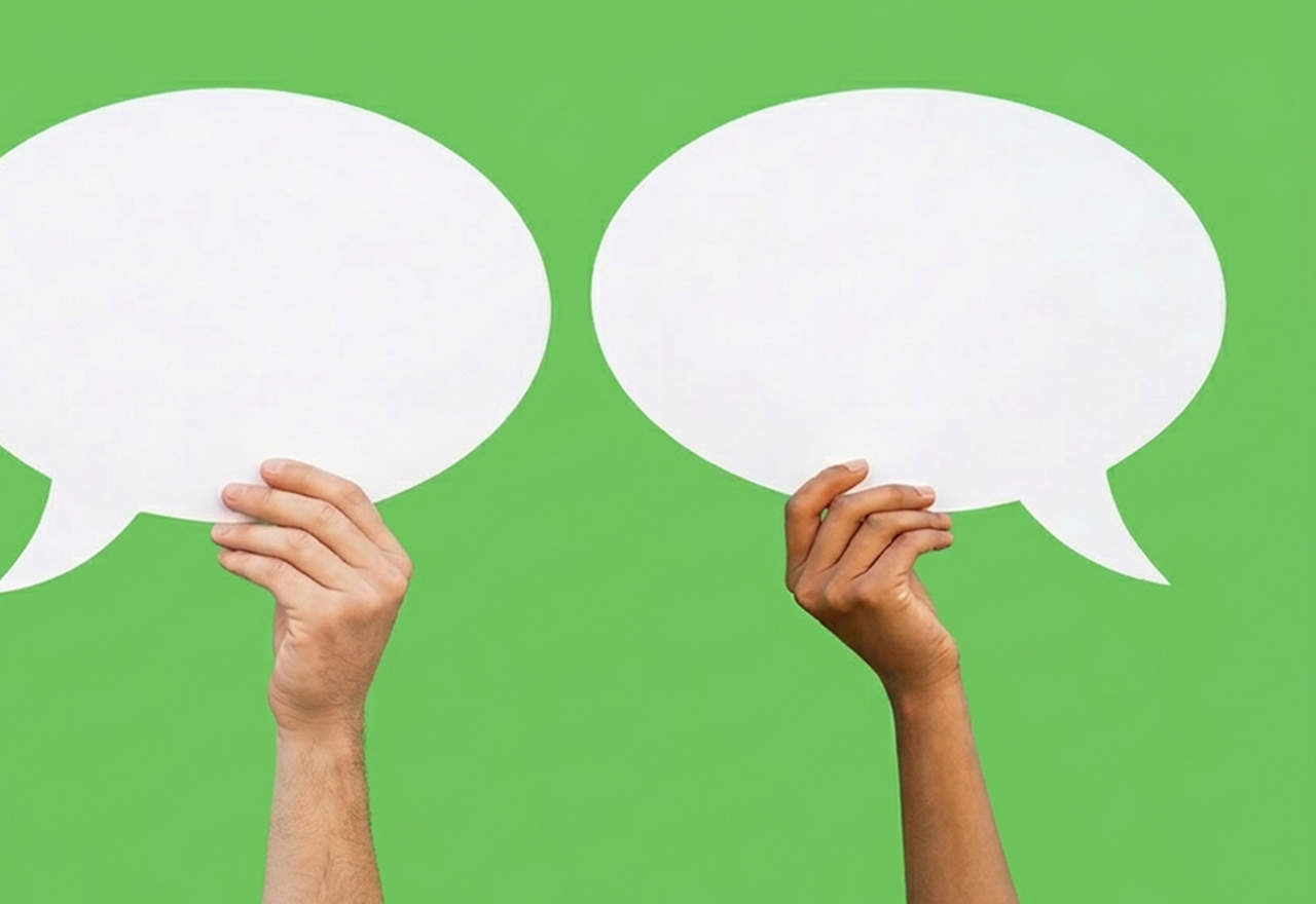 Two hands holding up speech bubbles